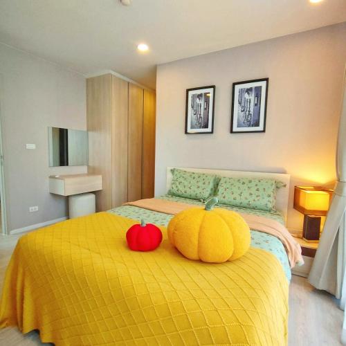 a bedroom with two pumpkins sitting on a bed at CM Design Space in Ninman MAYA in Chiang Mai