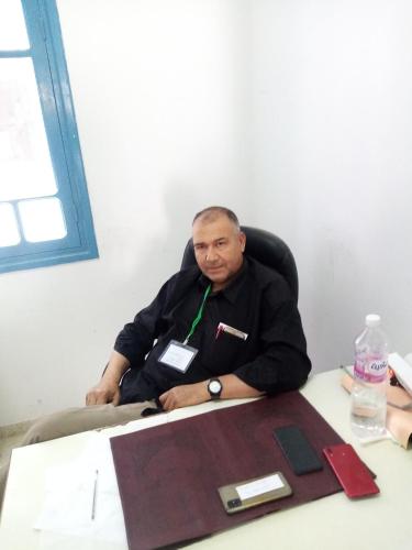 a man is sitting at a table with at Appartement Daly in Raoued