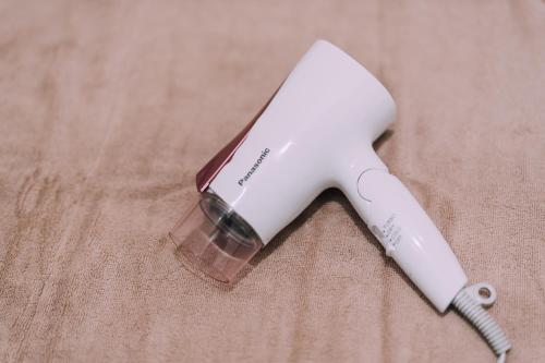 a white hair dryer sitting on top of a table at Yuzawa Onsen Lodge 1min to LIFT A House in Seki