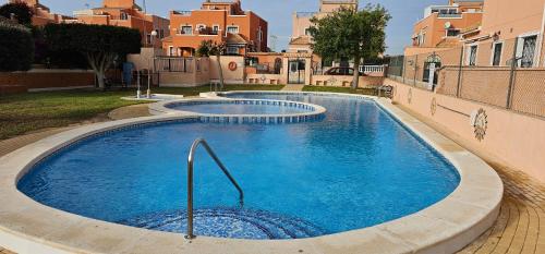 2 piscines d'eau bleue dans une cour avec des bâtiments dans l'établissement Casa Azul, à Alicante