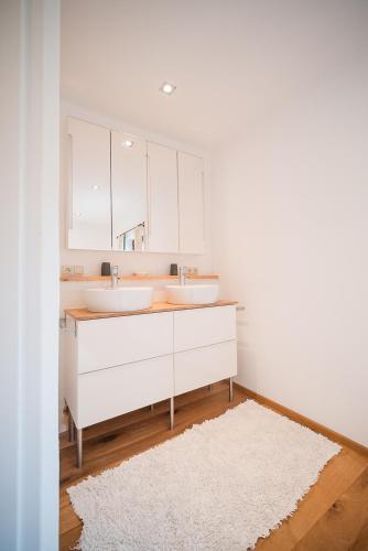 a bathroom with two sinks and a mirror at Altes Bauernhaus von 1756 - Villa Straussengut in Bad Aussee