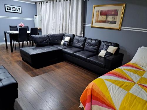 a living room with a black couch and a table at Granville appartment in Chicago