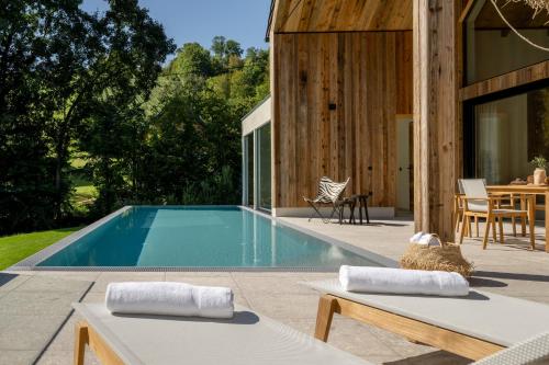 a swimming pool in the backyard of a house at Julianhof Premium Guesthouse & Spa in Straden