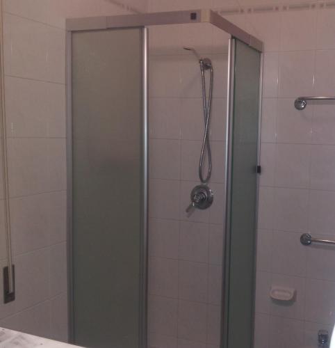 a shower with a glass door in a bathroom at Hotel Montecarlo in Chianciano Terme