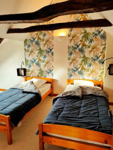 a bedroom with two beds and a wall with palm trees at Gite 3étoiles Coconning dans une grange cantalienne - Cantal Emotions Valette Auvergne in Valette