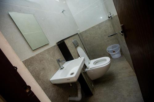 a bathroom with a toilet and a sink and a mirror at THE PARK AVENUE HOTEL - Business Class Hotel Near Central Railway Station Chennai Periyamet in Chennai