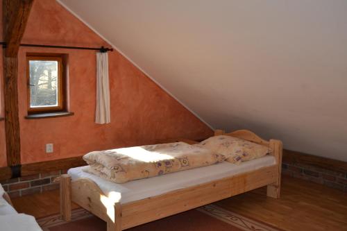 a bed sitting in a room with a staircase at chalupa Stritez in Střítež