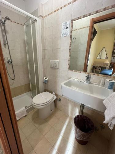 a bathroom with a toilet and a sink and a shower at Hotel Mariano in Rome