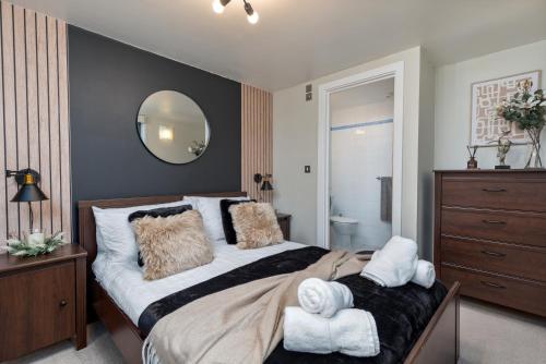 a bedroom with a large bed and a mirror at Urban Oasis: Heart of City by Train in Leeds