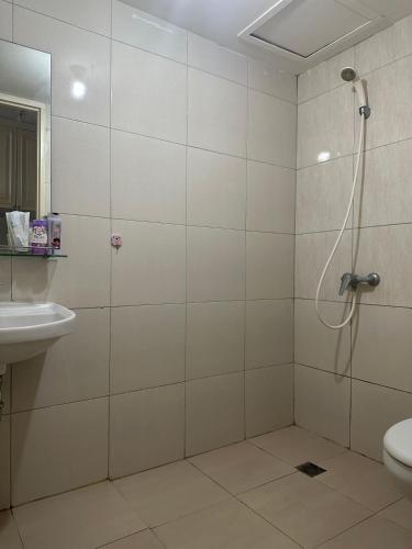 ein Bad mit einer Dusche, einem WC und einem Waschbecken in der Unterkunft Tanglin Orchard Apartment by Kondoku in Lontar