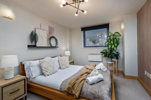 a bedroom with a large bed and a window at Urban Oasis: Heart of City by Train in Leeds