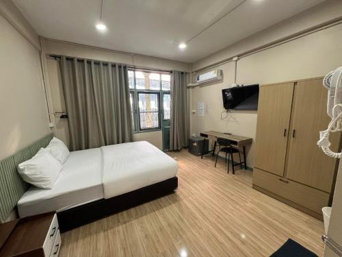 a bedroom with a bed and a desk in it at Bangwa House - MRT Bangwa Station in Bangkok