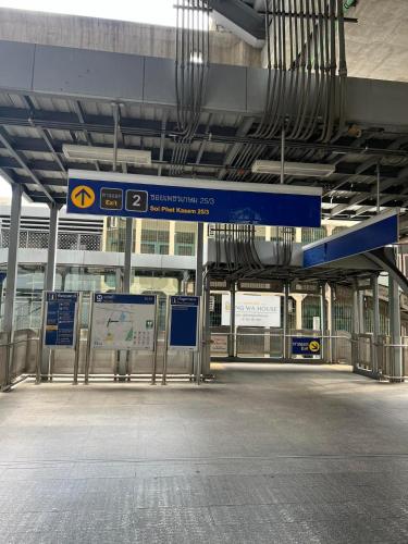 an empty train station with a blue sign in it at Bangwa House - MRT Bangwa Station in Bangkok