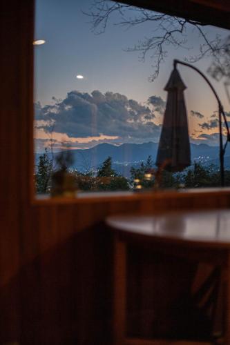 a view of a sunset through a window at kamenos Luxury Resort With Beautiful Scenery Hiji in Hiji