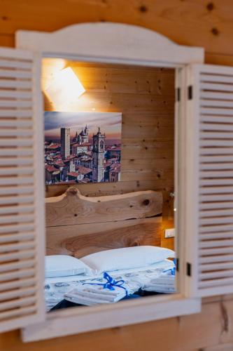 a bedroom with a bed with a wooden wall at Agriturismo La Soglia Del Parco in Ranica