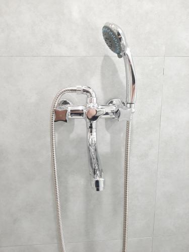 a shower in a bathroom with a shower head at Marjani Terrace Rooms in Tbilisi City