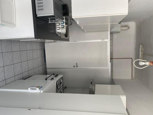 a small kitchen with a stove and a microwave at Apartments Johann in Vienna