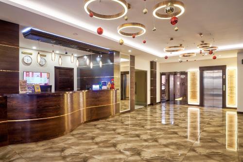a lobby of a hotel with a bar at Aisha Bibi Apart Hotel & Spa in Astana
