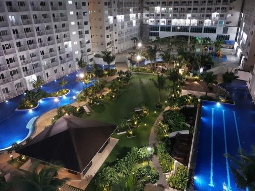 an aerial view of a courtyard at night with buildings at Luxury Seaside Sunset view at the Shore Mall of Asia in Manila