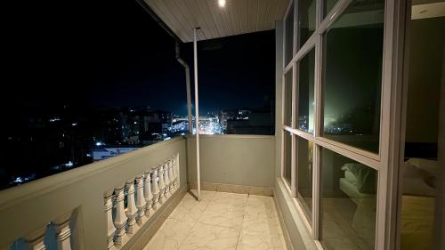 a balcony with a view of the city at night at CityView Homestay in Imphal