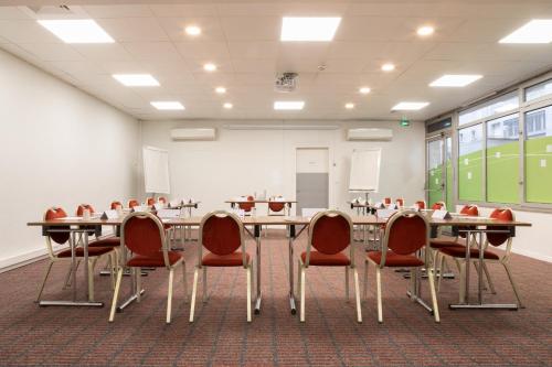 a conference room with a long table and chairs at Holiday Inn Express Amiens by IHG in Amiens