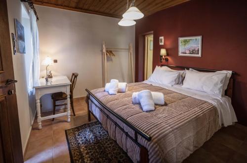 a bedroom with a large bed with towels on it at Gorianades Traditional House in Gorianádhes