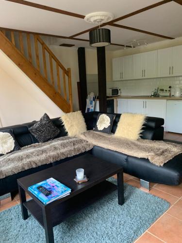 uma sala de estar com um sofá e uma mesa de centro em Willow Farm Gite em Saint-Martin-de-Chaulieu