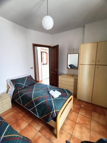 a bedroom with a bed and a mirror at A Casa dei Nonni in San Demetrio neʼ Vestini