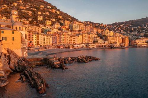 a view of a city with a beach and buildings at Beautiful house with lovely sea view terrace in Camogli