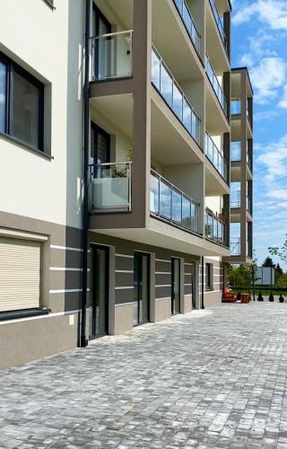 a large apartment building with a brick driveway at Apartamenty Przemyśl BG in Przemyśl