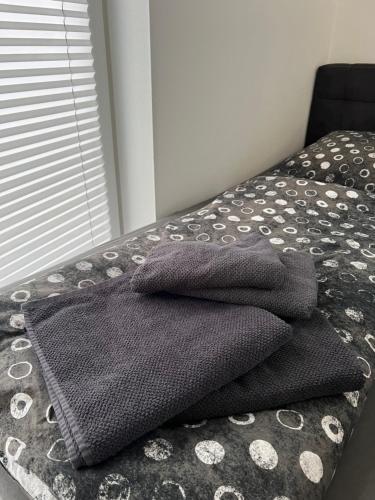 een stapel handdoeken bovenop een bed bij Schöne gemütliche Wohnung, Ferienwohnung in ruhiger Lage in Auerbach