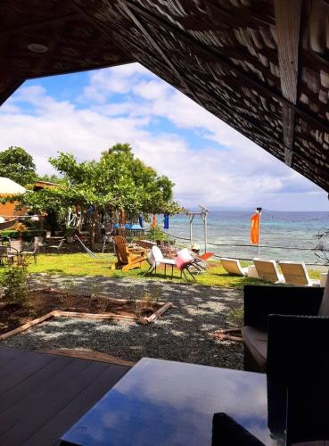 a view of the beach from the deck of a house at JUSH NATIVE AND GLAMPING in Dauis