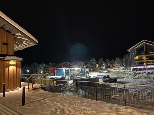 a building in the snow at night at Levi Cranberry C1, ski-in ski-out 2 bedroom apartment in Levi center in Levi