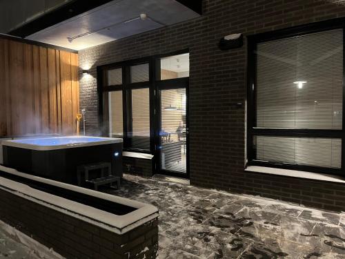a bathroom with a tub in a brick building at Levi Cranberry C1, ski-in ski-out 2 bedroom apartment in Levi center in Levi