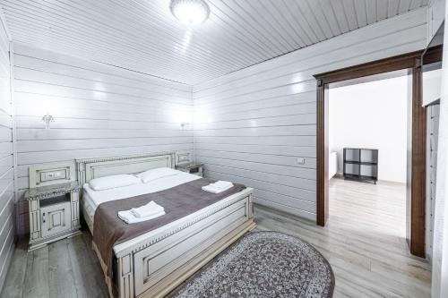 a white room with a bed and a window at Diamond Resort White in Bukovel