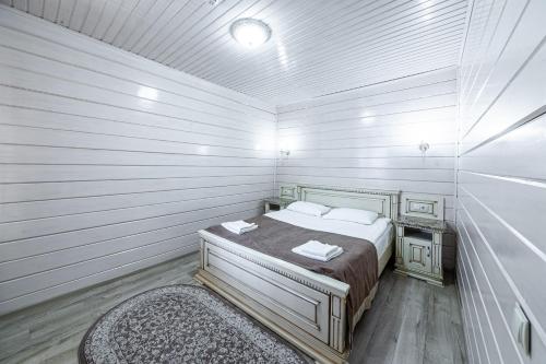 a small bedroom with a bed and a rug at Diamond Resort White in Bukovel