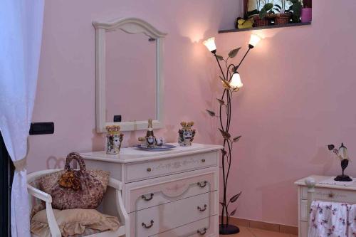 a bathroom with a sink and a mirror on a dresser at Villa Anna in Minori