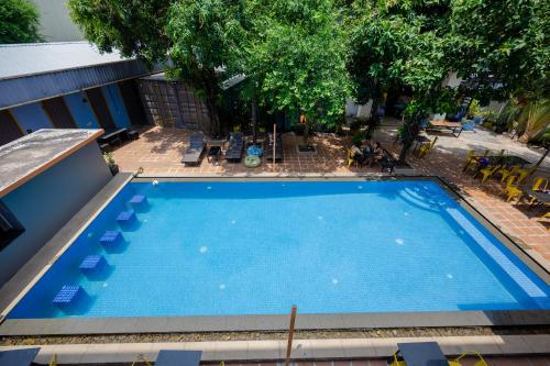 an overhead view of a large blue swimming pool at White Rabbit Hostel in Siem Reap