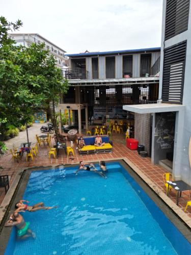 a group of people swimming in a swimming pool at White Rabbit Hostel in Siem Reap