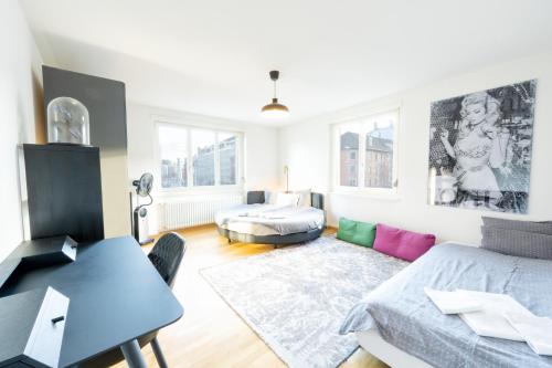 a living room with a bed and a table at Loving apartment right in the heart of Zurich! in Zurich