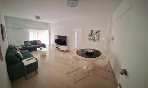 a living room with a couch and a table at Cozy 2 Bdr Nicosia City Free Parking Wifi in Nicosia