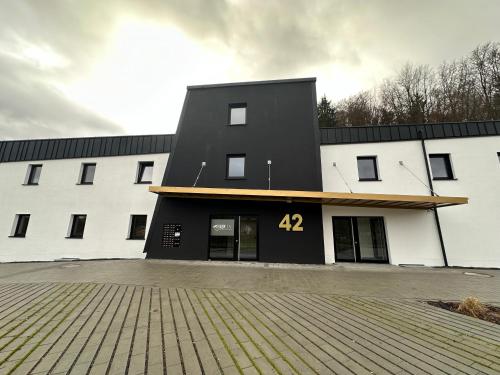 a black and white building with the number on it at GreenLeaf Regensburg I Sinzing in Sinzing