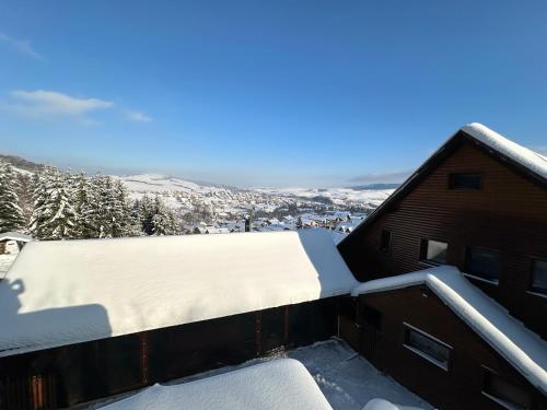 a snow covered roof of a building with a view at Ubytovanie Privat Antoni - apartmán v RD in Tvrdošín