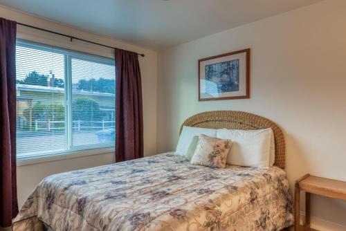 a bedroom with a bed and a window at The Lighthouse in Lincoln City in Lincoln City