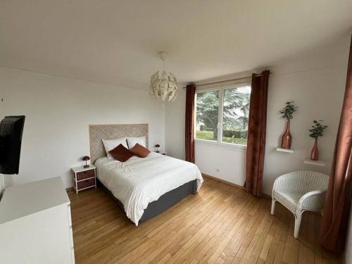 a bedroom with a white bed and a window at Douceur champenoise in Dizy