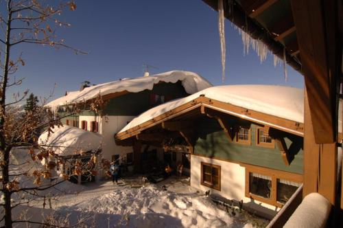 a house with snow on the top of it at Hochberghaus Resort in Grünau im Almtal