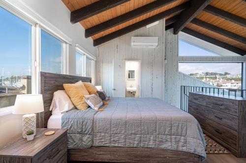 a bedroom with a bed and a large window at 1011 North Bayfront B in Newport Beach