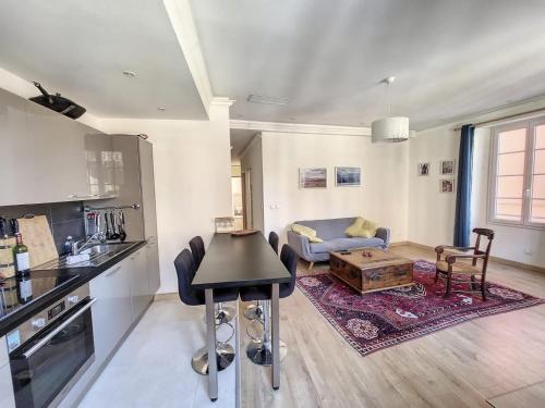 uma cozinha e sala de estar com um sofá e uma mesa em My Cosy Flat-Centre of Nice- Perfect location em Nice