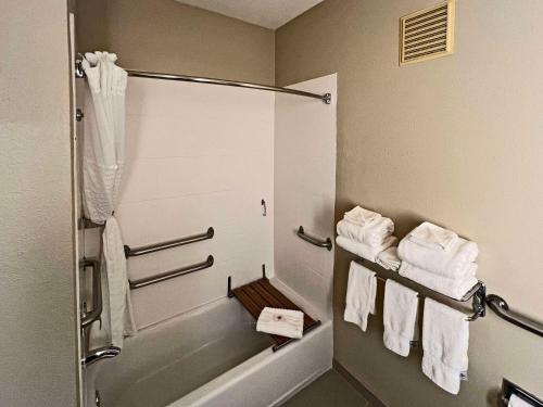 a bathroom with white towels and a shower at Comfort Suites Peoria Sports Complex in Peoria