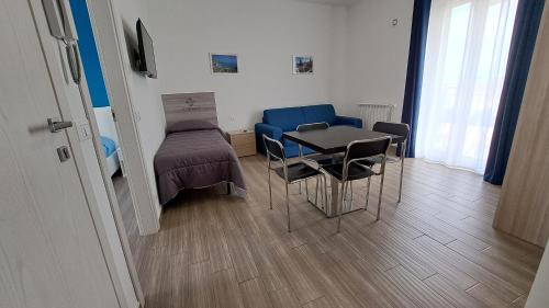 a room with a table and chairs and a bed at Le Due Sicilie B&B in Lascari